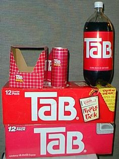 a table topped with a bottle of tab soda