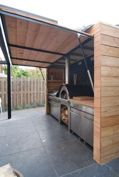 an outdoor bbq with grill and oven in it