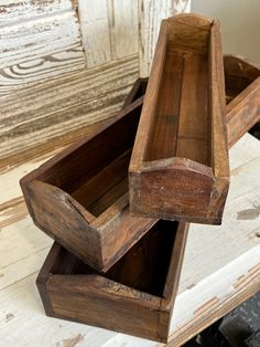 two wooden boxes sitting on top of a table