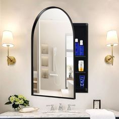 a bathroom with a sink, mirror and shelves on the wall next to each other