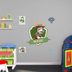 a child's bedroom with a wall decal featuring a cartoon character and the name wade