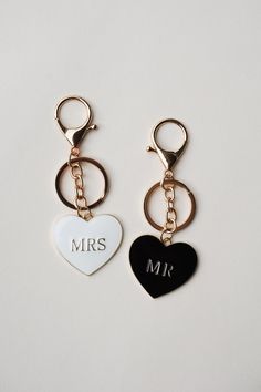 two personalized key chains are shown with a heart and mr and mrs on them