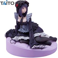 an anime figurine sitting on top of a purple object with chains around her ankles