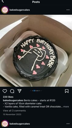 a birthday cake in a box with pink hearts on it