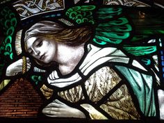 a stained glass window with an image of a woman holding a bird in her hand