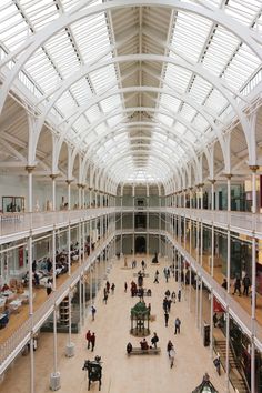 the inside of a building with people walking around