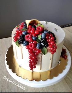 a cake decorated with berries, raspberries and blueberries