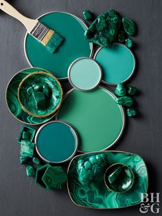 green and gold plates with paint brushes on them