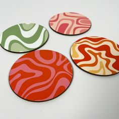 four coasters with different designs on them sitting next to each other in a circle