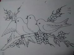 two birds sitting on a branch with flowers