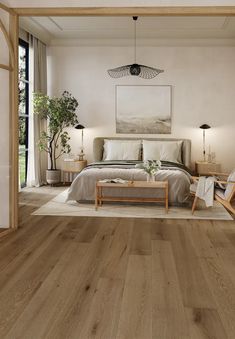 a bedroom with wood floors and white walls