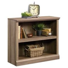 a wooden book shelf with a clock on top