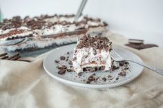 a piece of cake on a plate with a fork in front of it and another slice missing