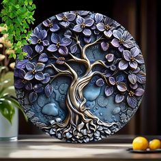 a blue plate with a tree on it next to some lemons and a potted plant