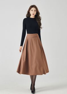 "Discover our classic brown wool A-line skirt, a timeless addition to your winter wardrobe. The rich brown color exudes sophistication, while the premium wool fabric ensures warmth and comfort. This versatile A-line skirt is perfect for both work and casual outings, making it a must-have choice for staying chic and cozy. DETAILS * 30% wool blend, 40% fiber and polyester, 40% nylon * Full polyester lining * Without pocket * Back zipper closure * Vintage inspired skirt * Suitable for autumn and winter  * Mid calf length * Dry clean MODEL SIZE Bust 85 cm(33.4\") Waist 67 cm(26.7\") Height 168cm (5' 6\") She wears size XS Choose CUSTOM Order if you * Need other color * Can't find your size in our size Chart * Chang the Length * Your Height is not Between 5'1\" - 5\"9\" * Your weight is not fro Beige A-line Pleated Skirt For Fall, Classic A-line Pleated Skirt For Fall, Elegant Fall Maxi Skirt For Office, Formal Long Skirt For Fall, Winter Office Brown Bottoms, Winter Workwear Lined Maxi Skirt, Winter Workwear Maxi Skirt With Lining, Lined Maxi Skirt For Winter Workwear, Fall Workwear Lined Maxi Skirt