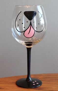 a wine glass with a dog's face painted on it