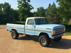 a light blue truck parked in a driveway