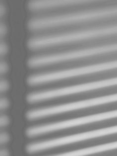 a black and white photo of the blinds on a window