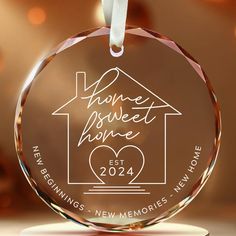 a glass ornament with the words home sweet home and a house on it