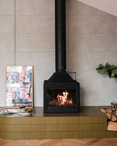 a fire place in a living room with wood burning