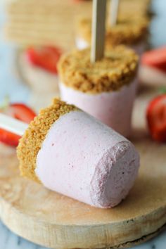 two popsicles with strawberries on top and the words 20 yummy popsicle recipes