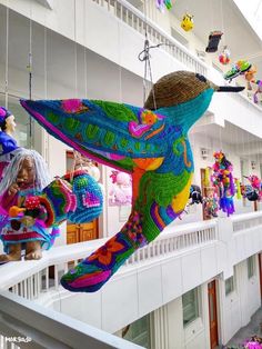 colorful stuffed animals are hanging from the ceiling