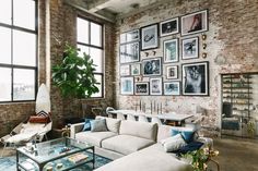 a living room filled with lots of furniture and pictures on the wall above it's coffee table