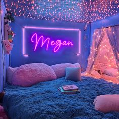 a bed room with a lit up neon sign above it