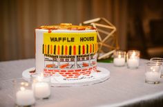 a table with candles and a cake on it that is shaped like a waffle house