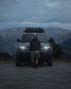 a man standing in front of an suv