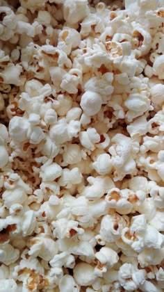 close up view of popcorn kernels in a bowl with no one on it's plate