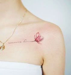 a woman's chest with a pink flower and the words love written on it