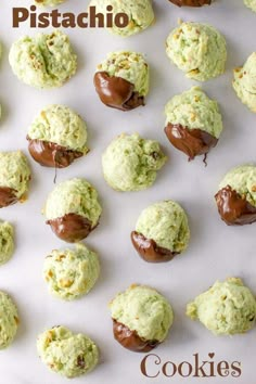 chocolate covered cookies are arranged on a white surface