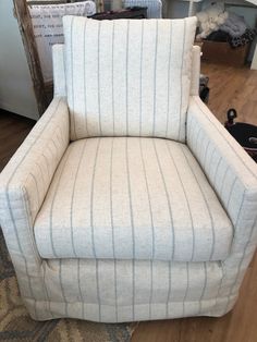 a striped chair sitting on top of a hard wood floor