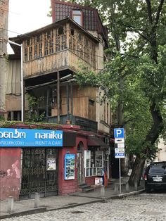 an old building with wooden balconies on the top floor and second story above it