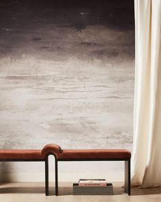 a bench sitting in front of a wall with a book on it's side