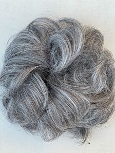 An elastic hair band tie around your hair for a secure fit Add volume to your thinning hair Make a ponytail-style messy bun Secure and comfortable to wear Transform your look in seconds🎀 Look as natural as your real hair Blends with your natural hair color ✨Material: 100% High Premium Quality Synthetic Hair Heat-ResistantWeight: 55g-60g Color Options: A wide range of hair color options is available to match different natural hair shades, including gray, salt and pepper, and white Silver Updo Wig, Messy Bun Hair Piece, Gray Clip In Hair Extensions, Clip In Hair Pieces Messy Buns, Salt & Pepper Hair Toppers, Fake Hair Buns, Messy Wavy Hair, Perfect Messy Bun, Curly Bun Hairstyles