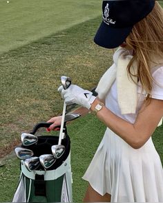 a woman in a white dress holding a golf club