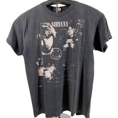 a black nirvana t - shirt hanging on a rack