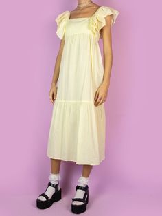 The Y2K Boho Tiered Midi Dress is a vintage light pastel yellow dress with a slightly transparent tiered design and ruffles on the straps. Summer 2000s beach cover up maxi dress. Boho Summer Style, 2000s Boho, Boho Fashion Summer, Y2k Boho, Dress With Ruffles, Tiered Midi Dress, Boho Summer