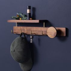 a hat hanging from a wooden shelf on a wall