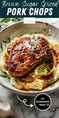 pork chops with mashed potatoes and gravy in a white bowl on a marble table