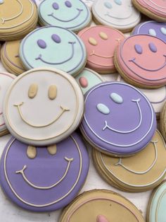 many decorated cookies with smiley faces on them