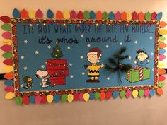 a bulletin board with peanuts and charlie brown on it's side that says, it is not what under the tree that matters