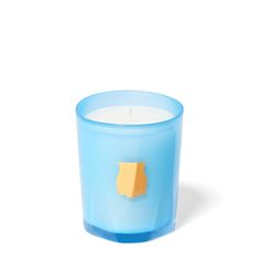 a blue candle with a piece of yellow paper stuck to it