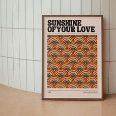 a framed poster with the words sunshine of your love printed on it in front of a tiled wall