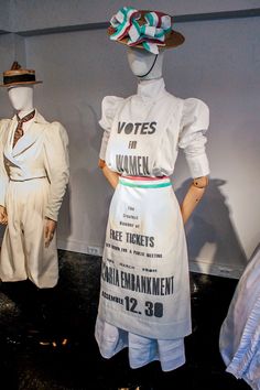 two mannequins dressed in white clothes and hats