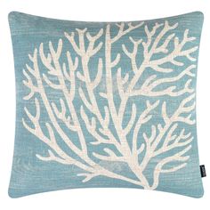 a blue pillow with white corals on it