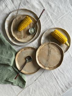 corn on the cob is sitting on two plates