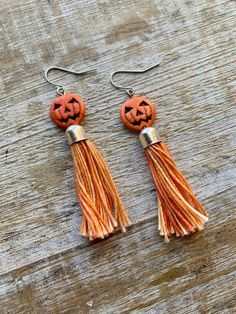 Handmade with howlite pumpkin beads and orange threaded tassels 🎃 Earrings measure 2 7/8 inches long. These can be made into infinity wires for people with tunnel gauges. Message me if this is what you need! Orange Tassel Drop Earrings As Gift, Orange Tassel Drop Earrings For Gift, Orange Tassel Drop Earrings, Adjustable Dangle Tassel Earrings As Gift, Orange Tassel Dangle Earrings, Adjustable Orange Tassel Earrings, Orange Beaded Tassel Earrings As Gift, Orange Tassel Earrings Gift, Orange Tassel Earrings